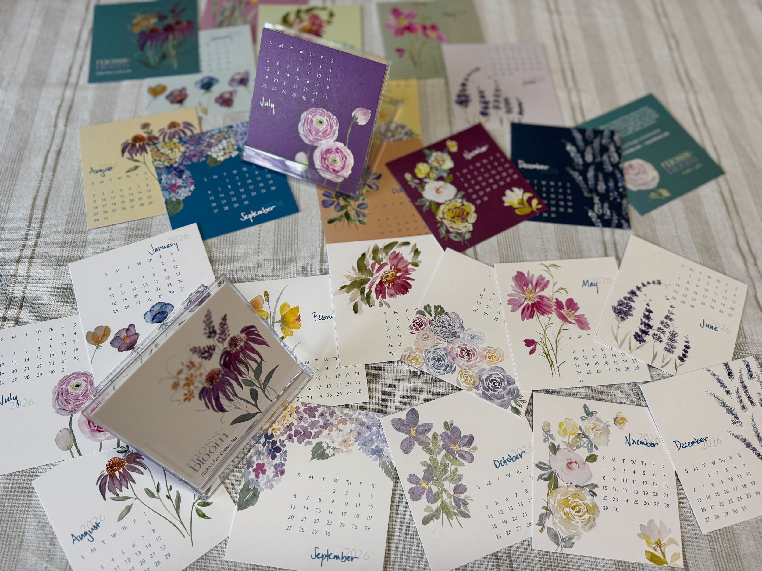 Collection of floral calendars cards on a textured surface