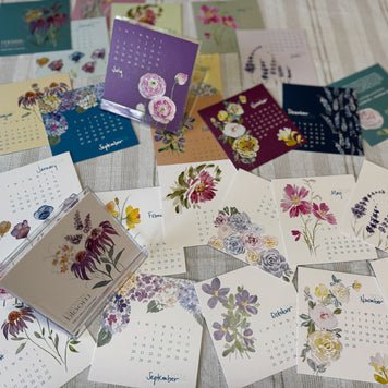 Collection of floral calendars cards on a textured surface